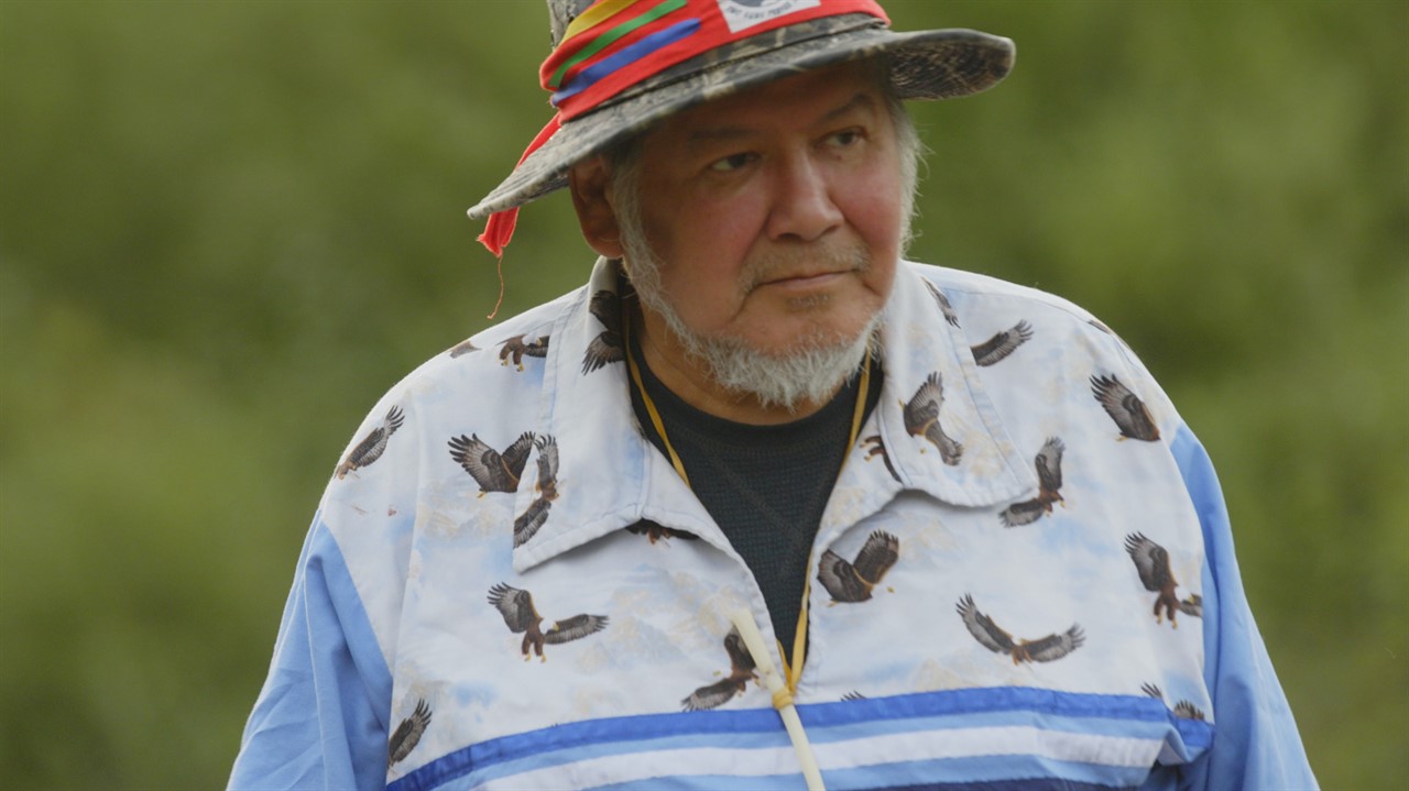 a man with a wide brim hat and a shirt with eagles