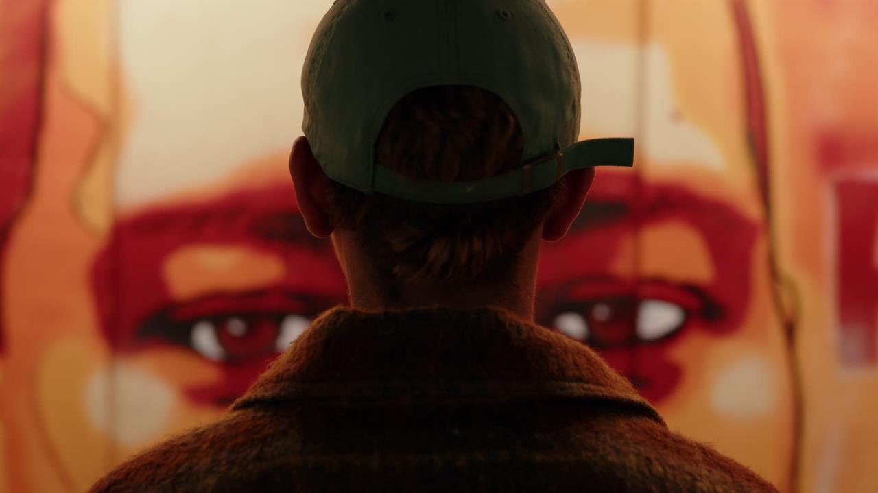 Black person looking at an illustration of eyes