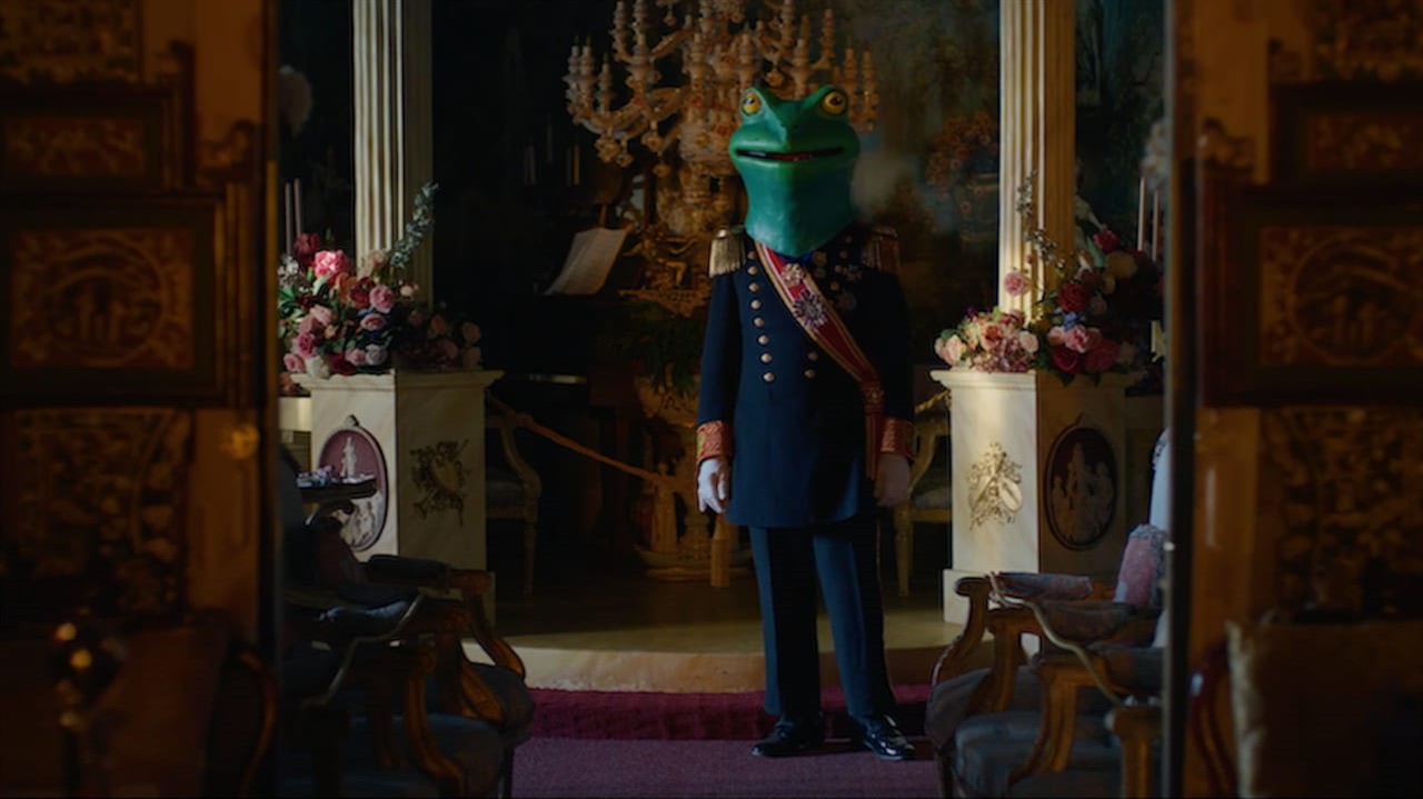 Person in British royal wear with a frog head