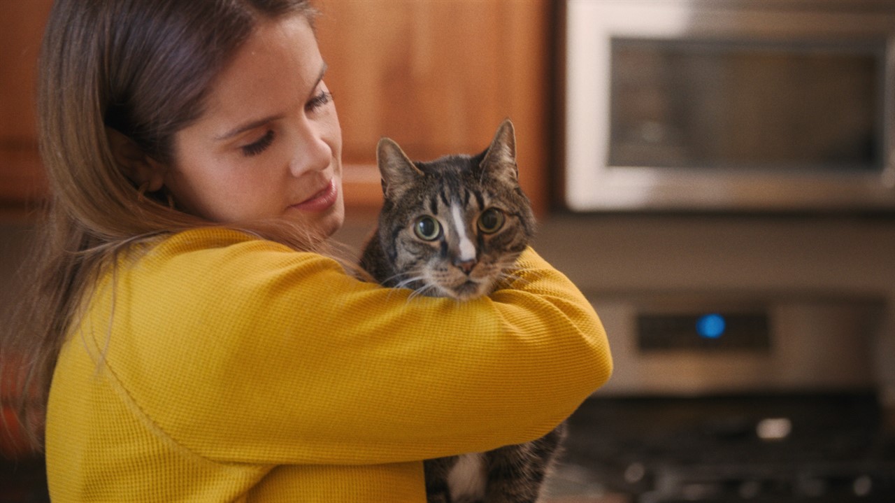 Woman cuddling a cat