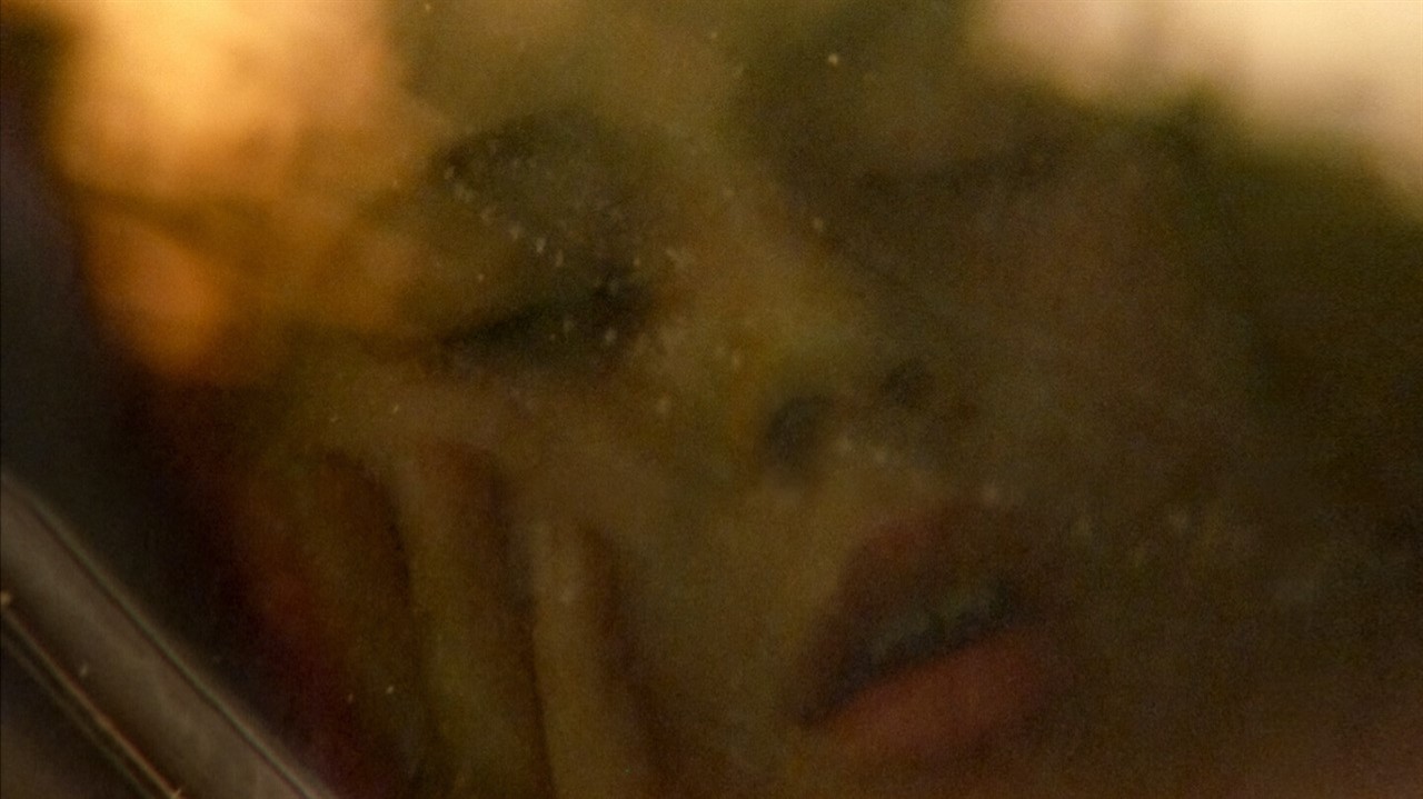 Closeup of a woman's face through a window