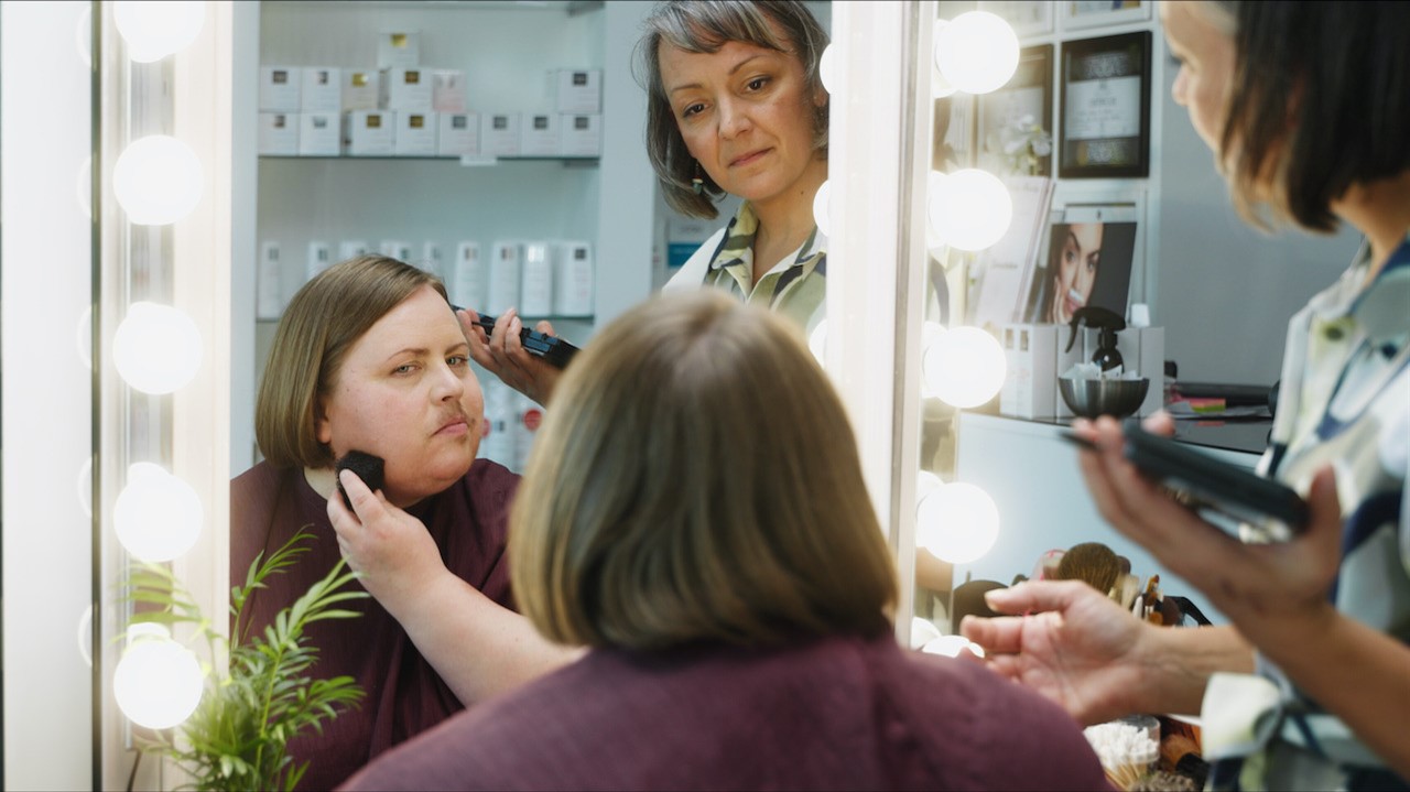 Makeup artist applying a beard to Late Mäntylä