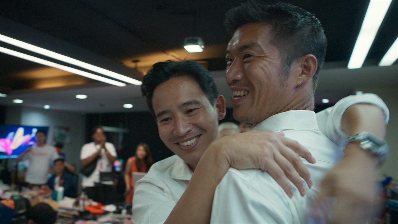 Two smiling men hugging
