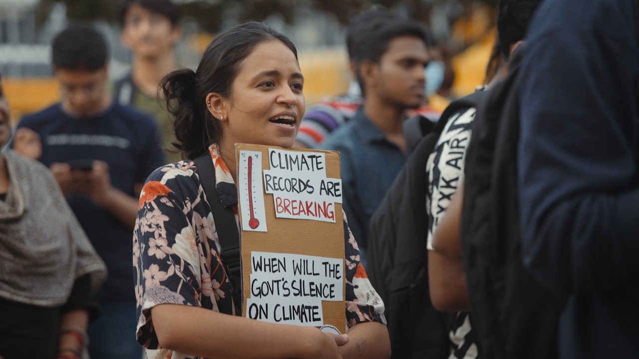 Woman with a sign about climate change