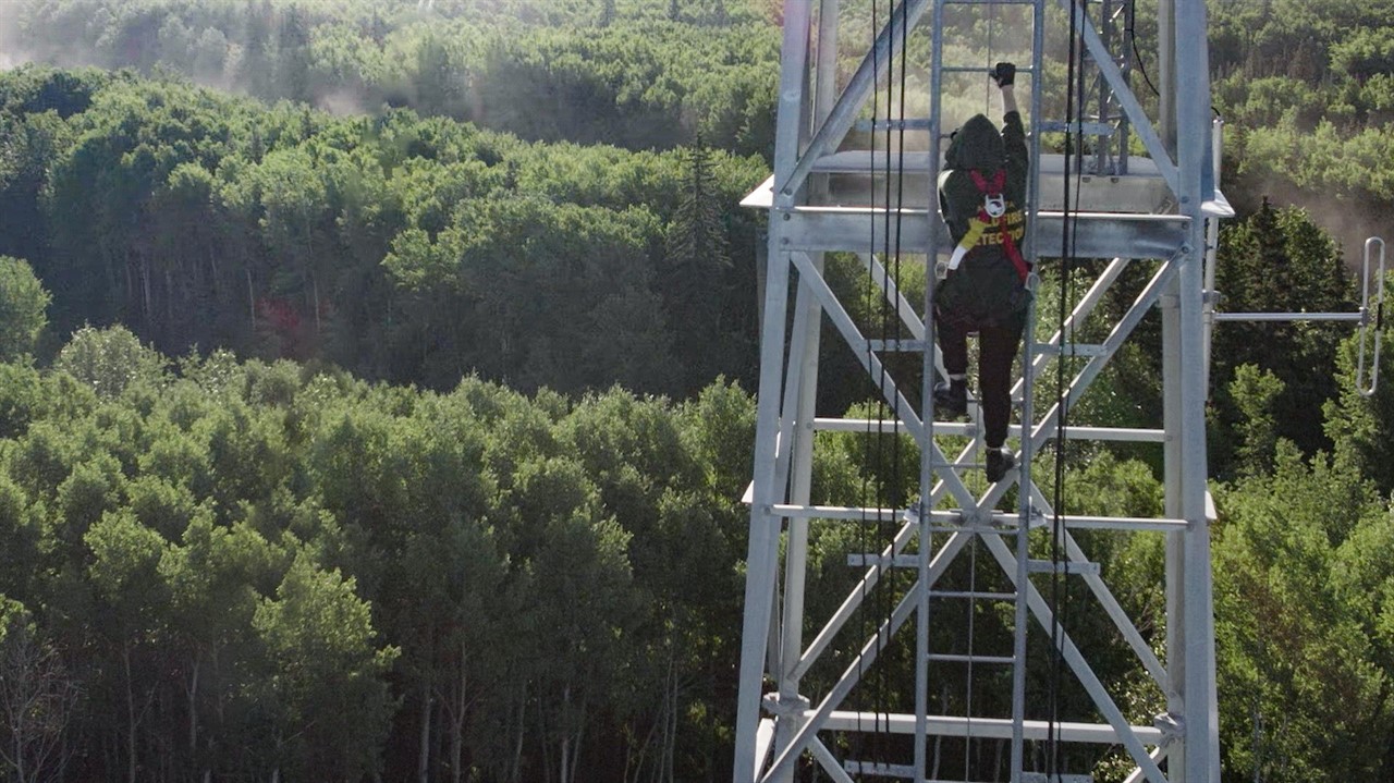 Person climbing the fire tower ladder
