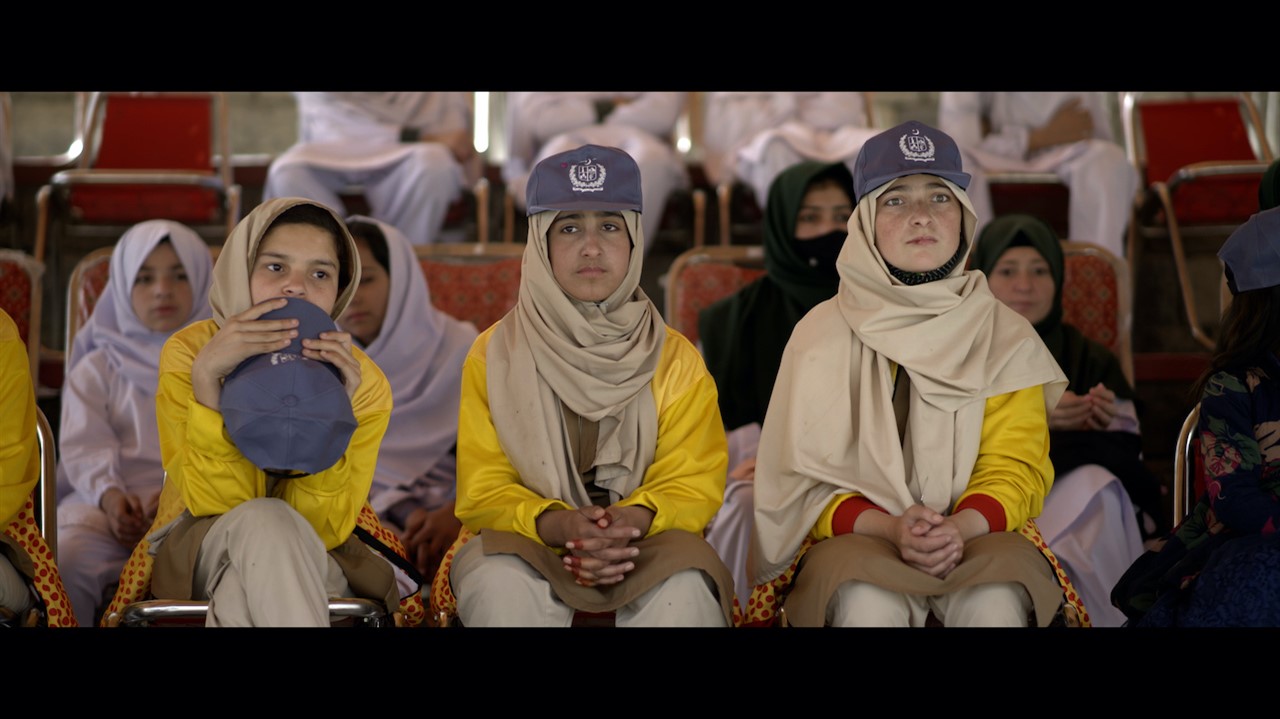 Young women in headscarves and baseball caps