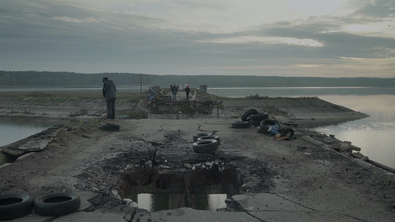 People examining a destroyed pier