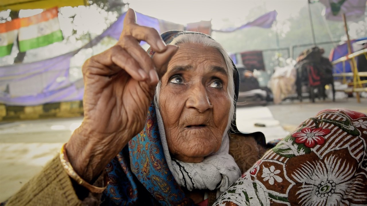 Old woman pointing to the sky