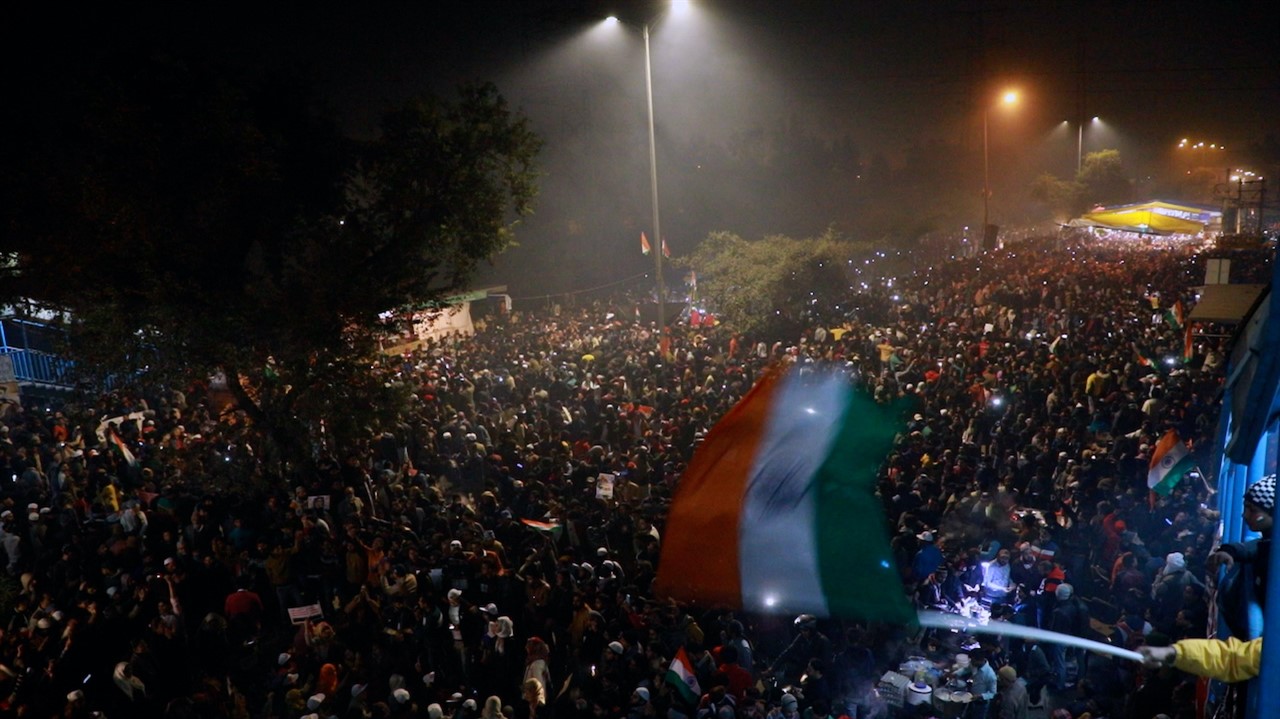 Large crowd of people fill the street