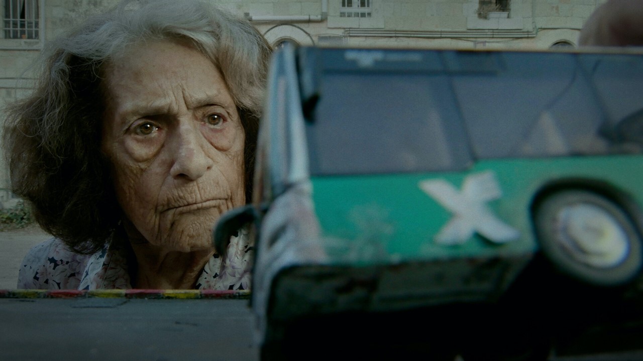 Old woman examining a tipping bus