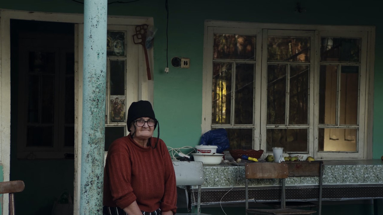 Elderly woman sits on a porch