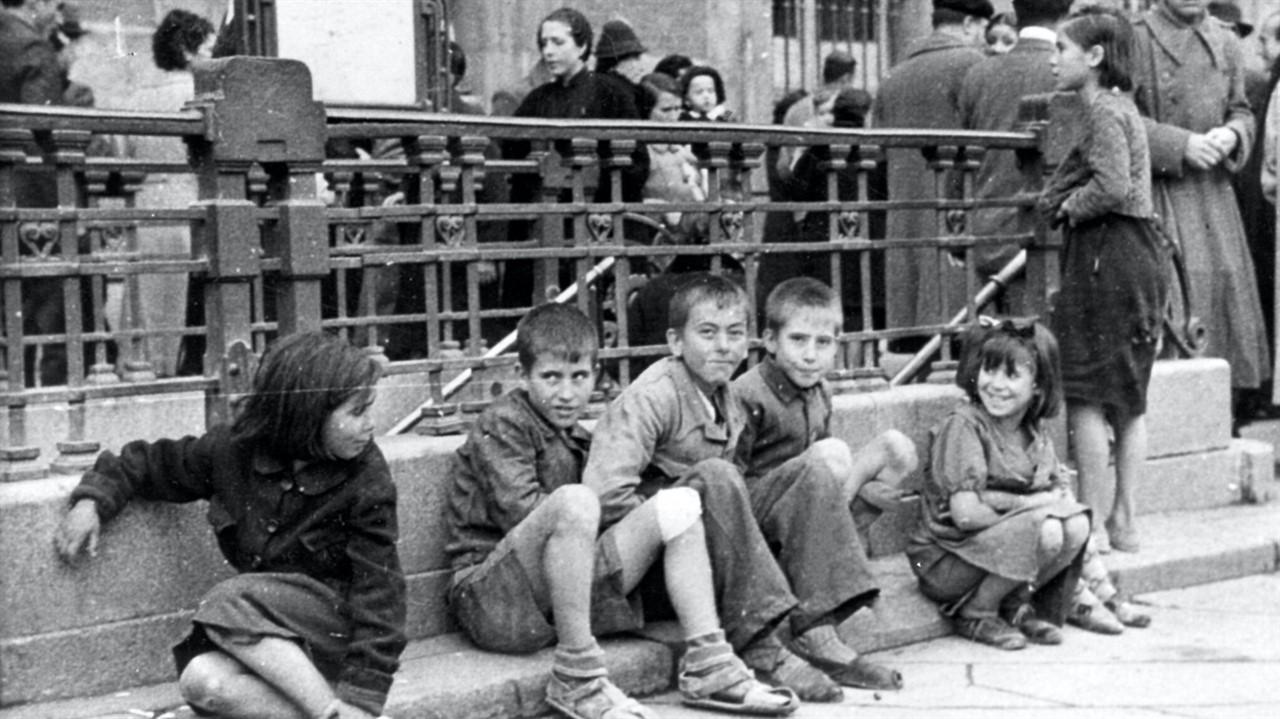 Children sitting on a curb