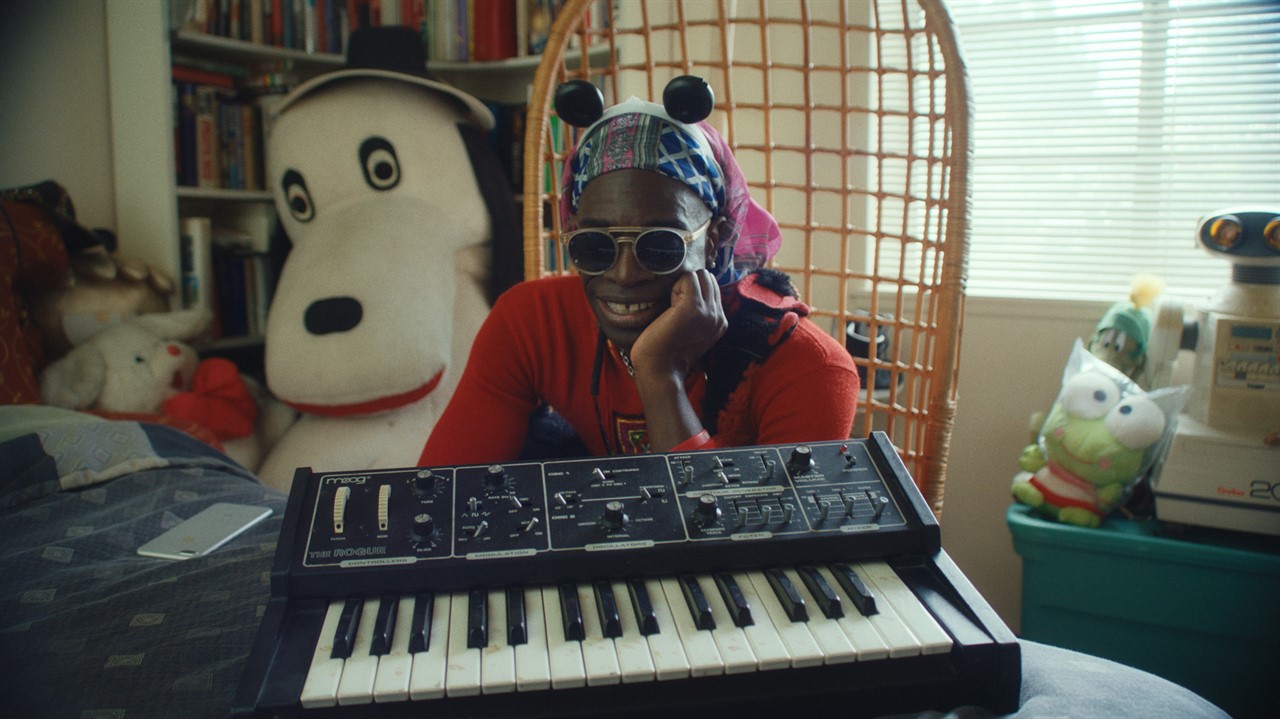 Man sitting by a small electric keyboard