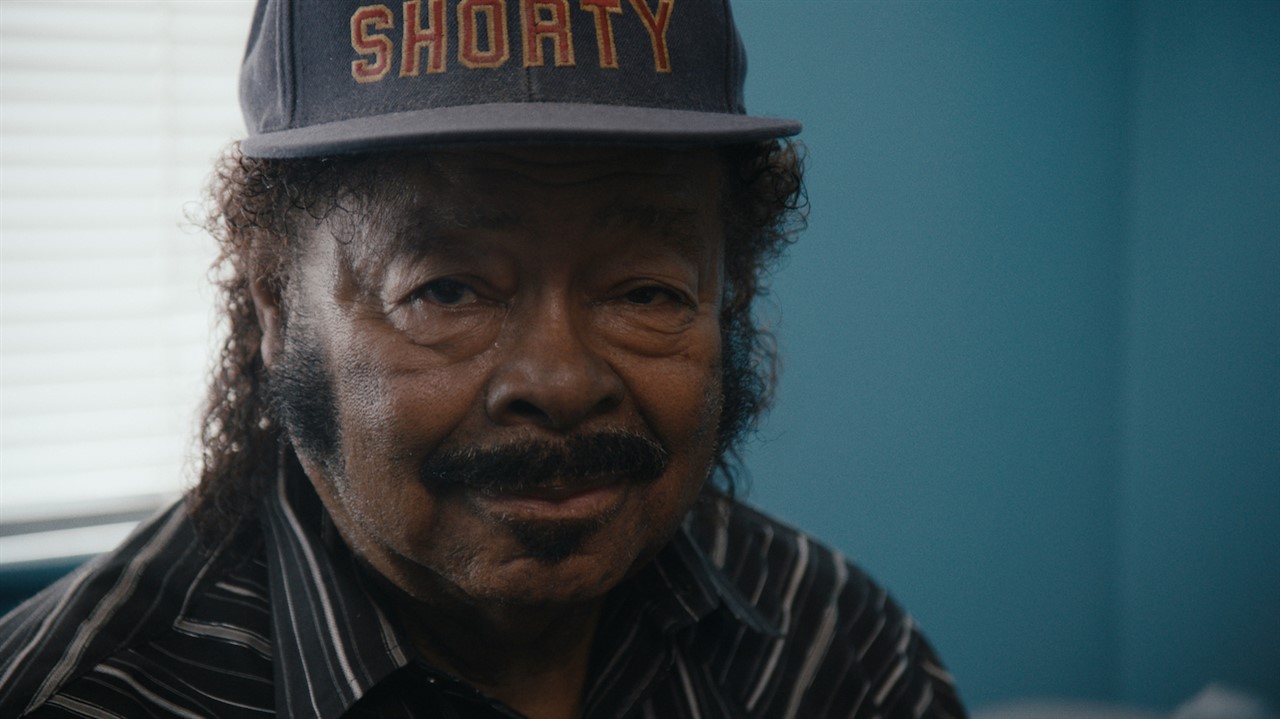 Closeup of a man in a ballcap that says Shorty