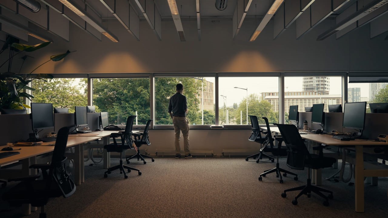 Man standing in an empty office, back to the camer