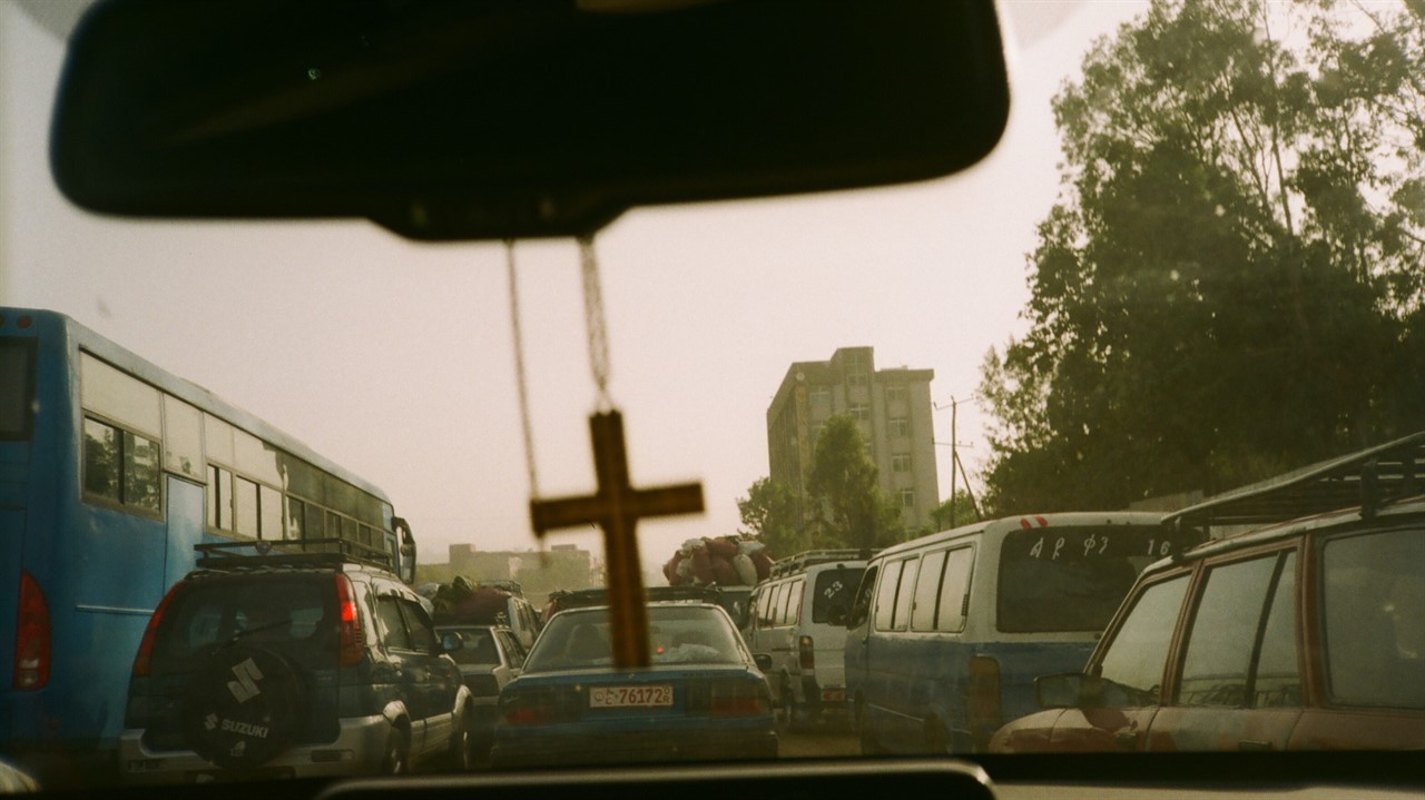 The Medallion Cross hanging from the rearview mirror of a car