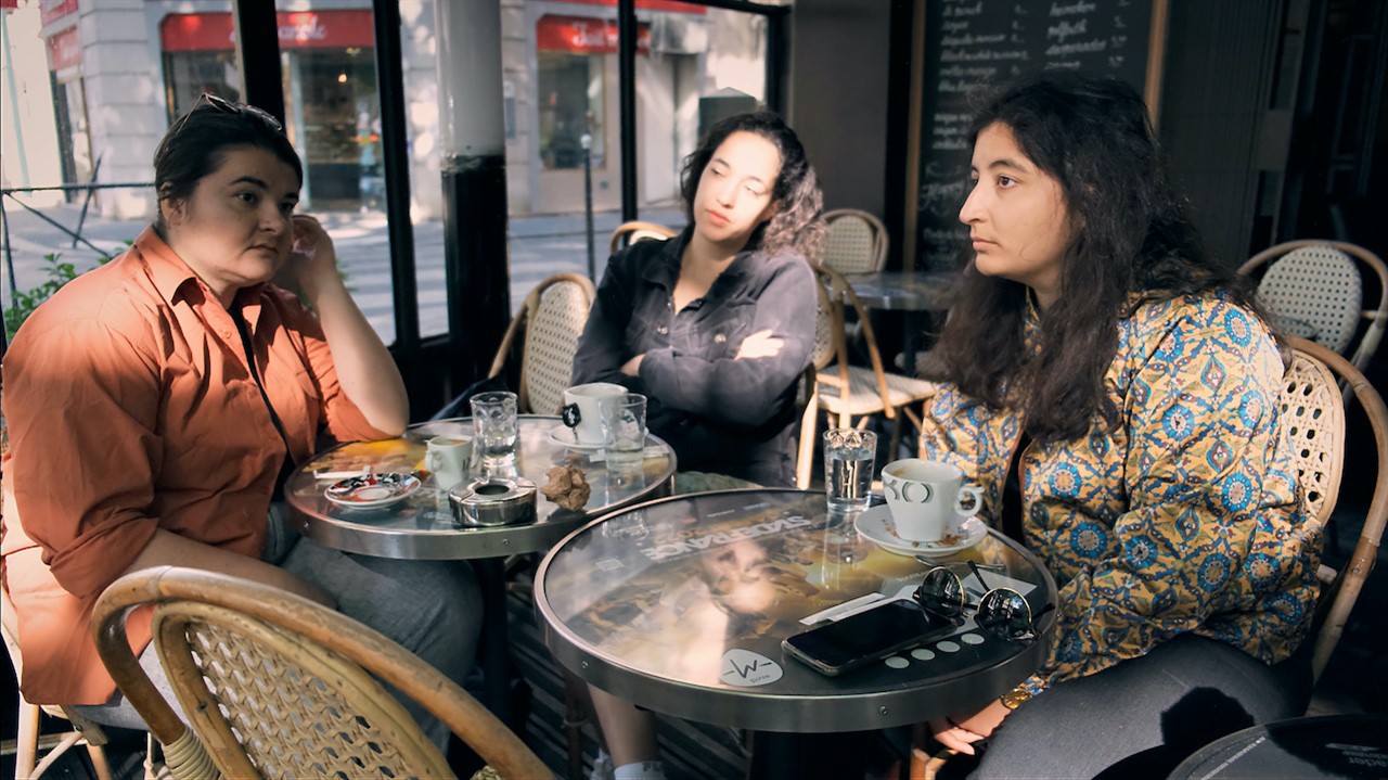 Three women sitting a cafe tables