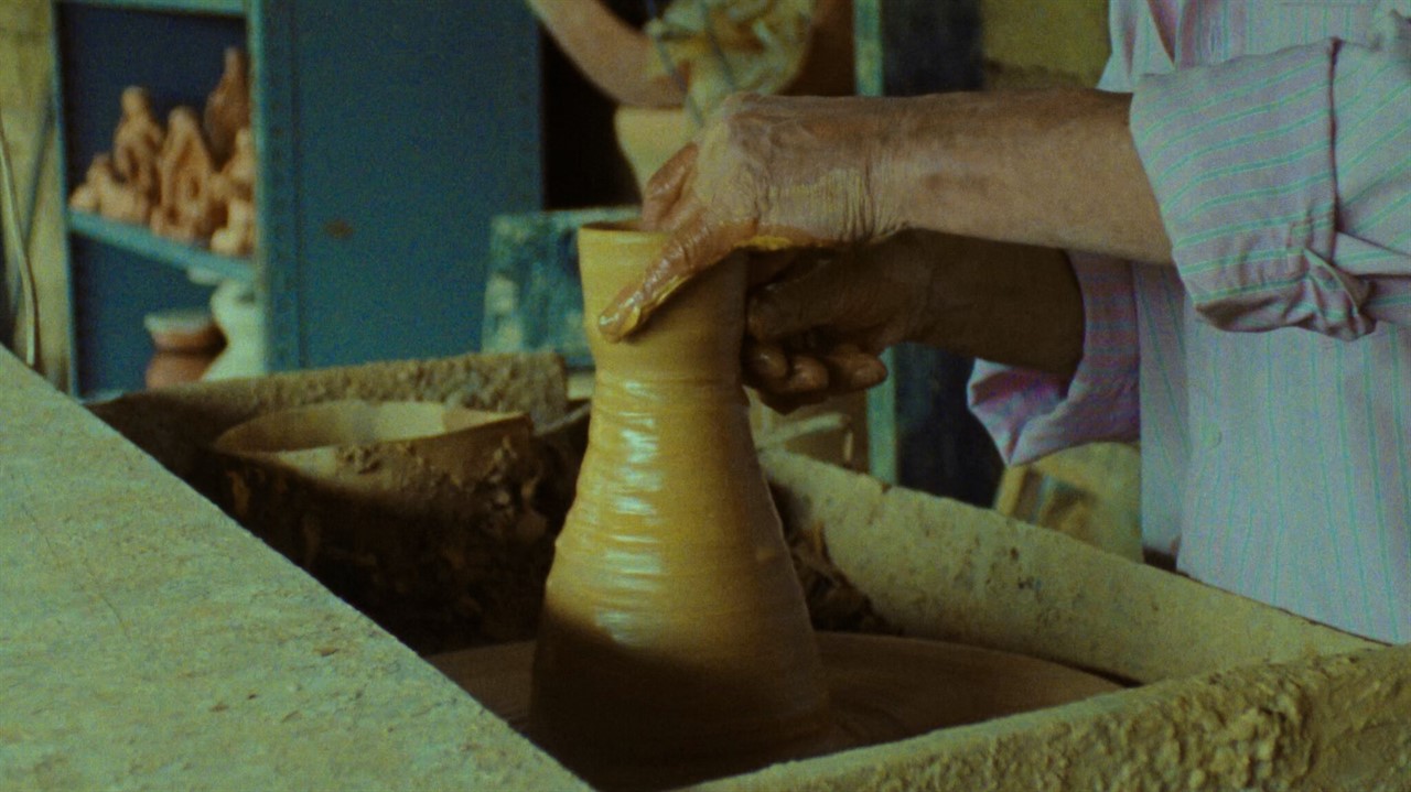 Person creating a pottery vase