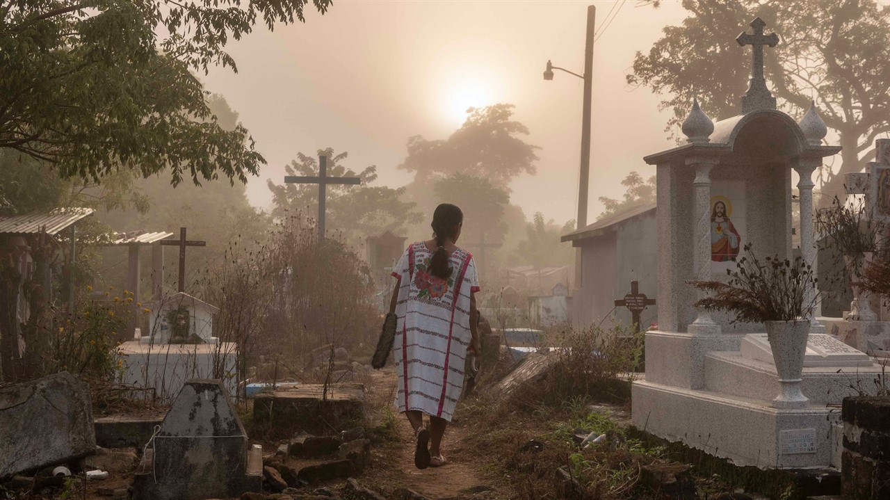 Woman walking through a graveyard