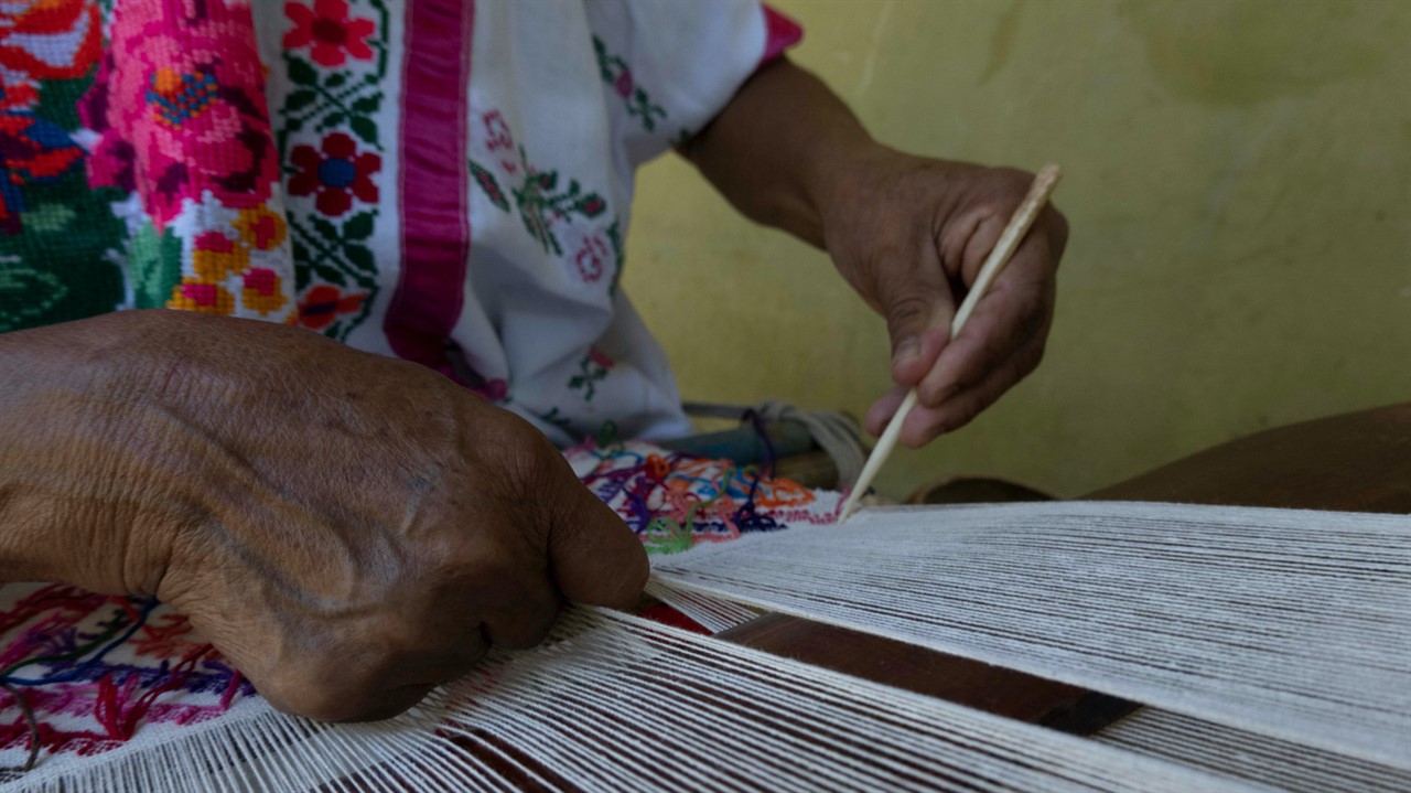 Closeup of hands weaving