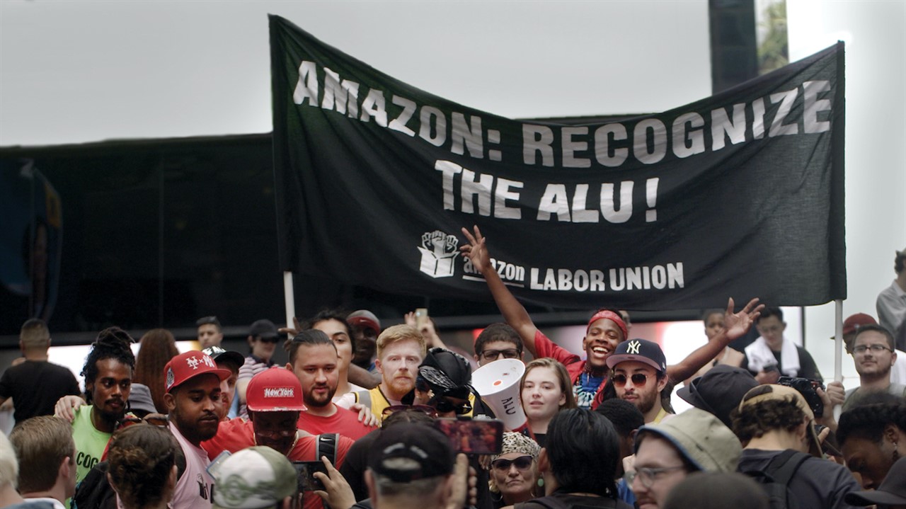 Protesters with sign: Amazon: Recognize the ALU