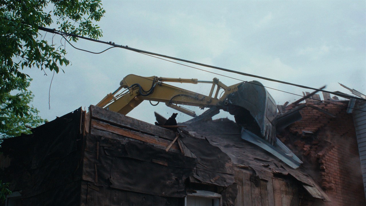 A house being demolished by machinery