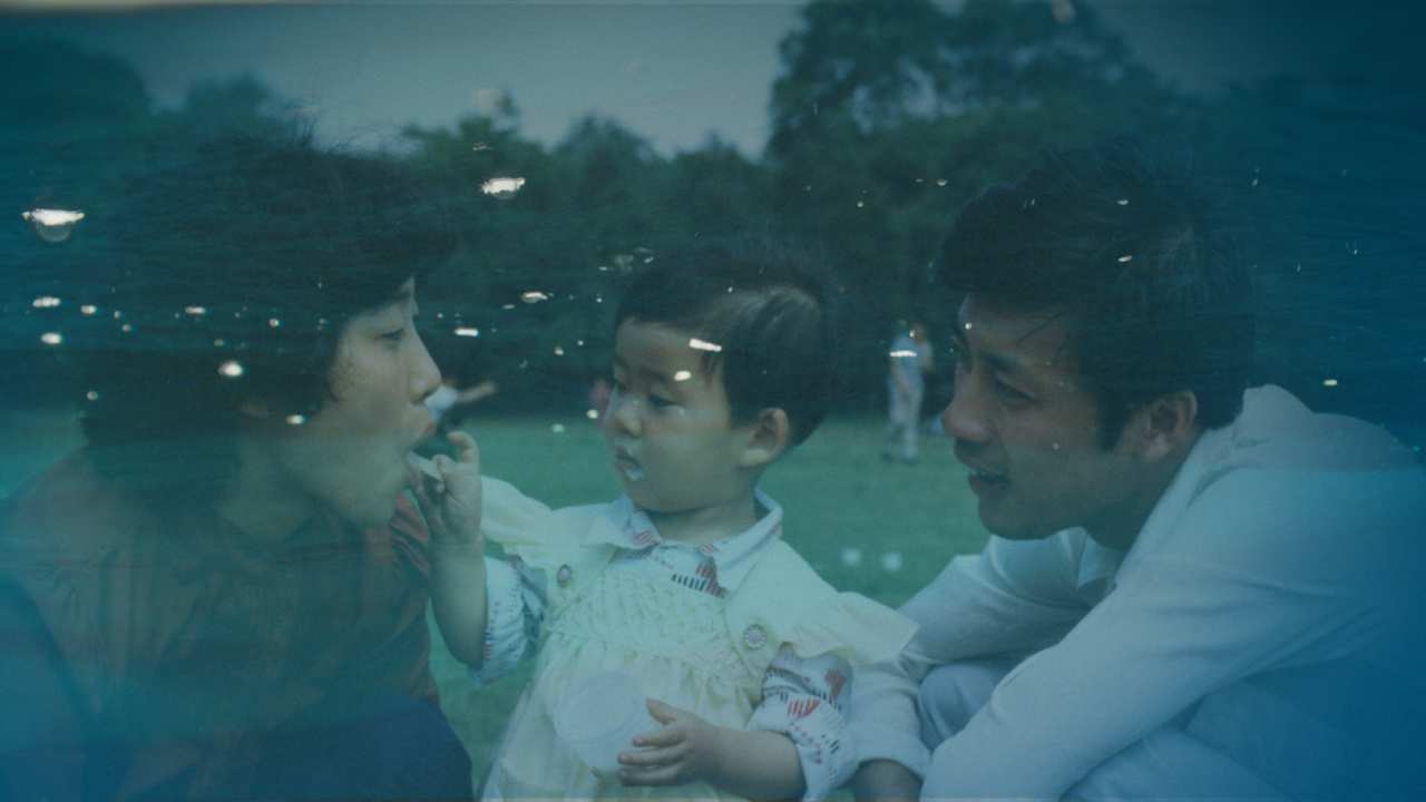 a vintage photo of a toddler with her parents