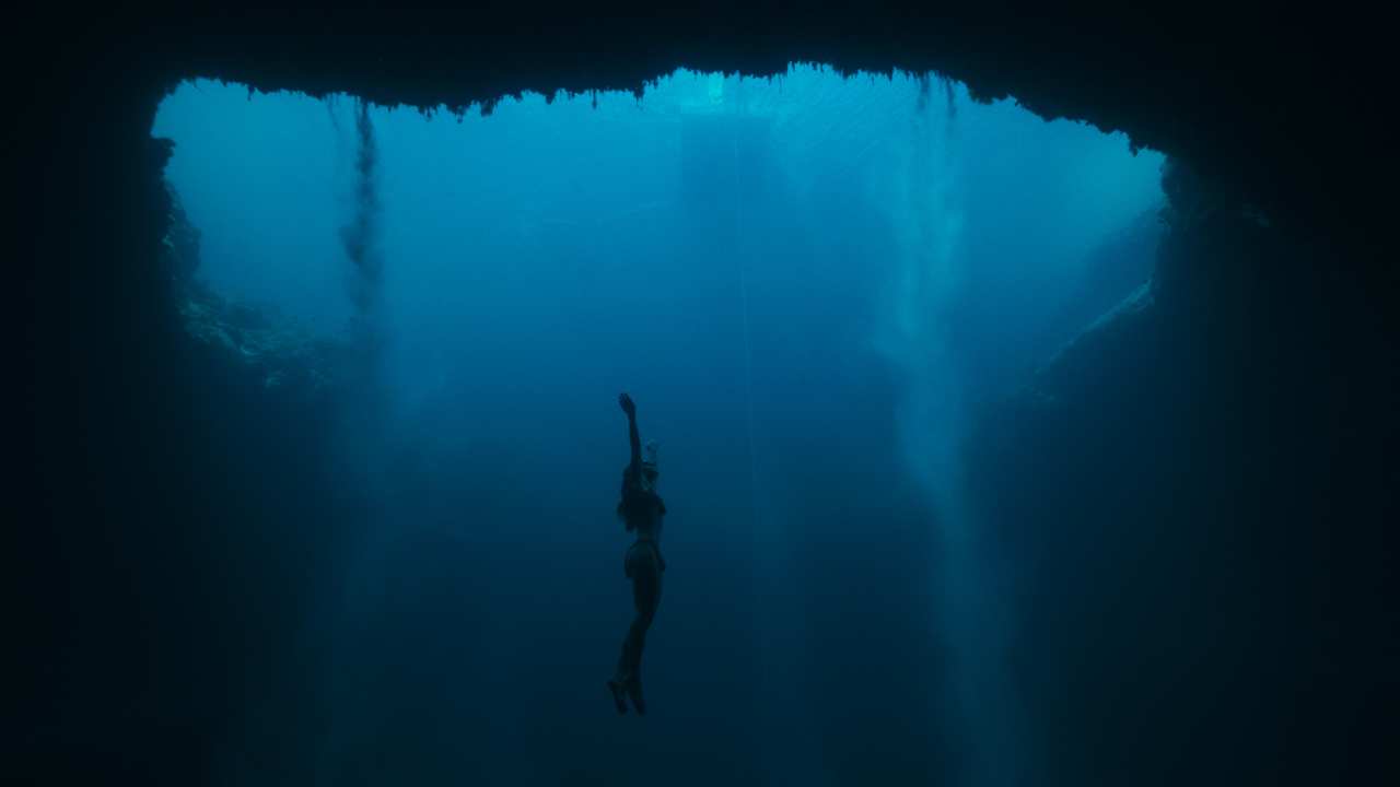 a young woman swimming to the surface