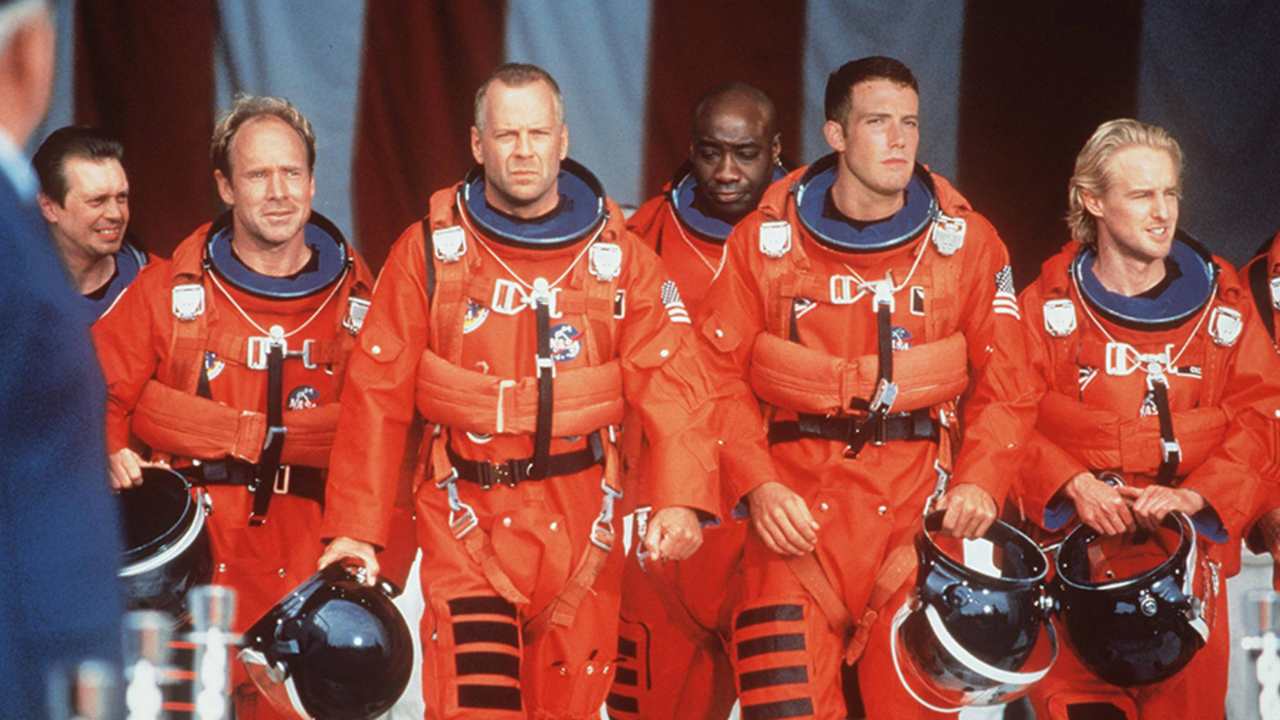 a group of men in red full body suits