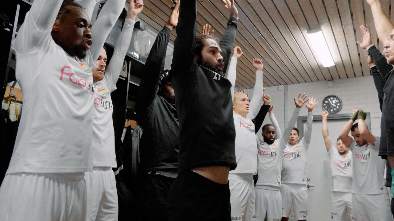 Soccer players stretching their arms in the air