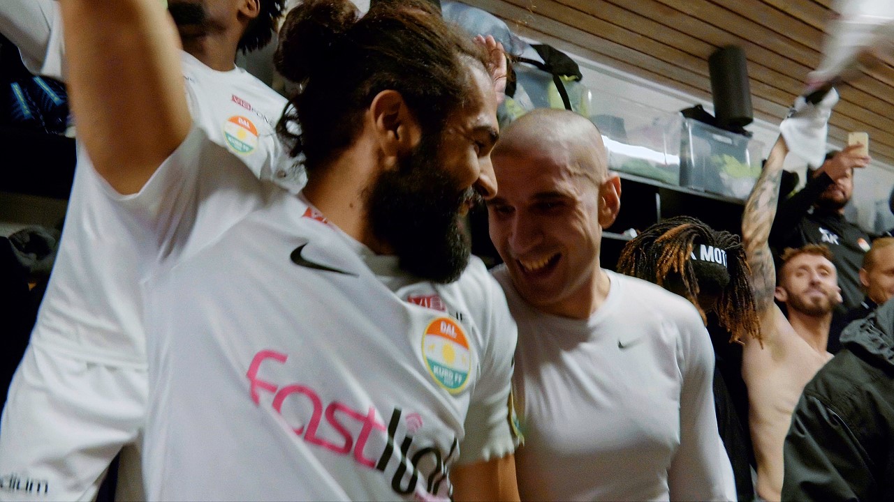 Two soccer players laughing