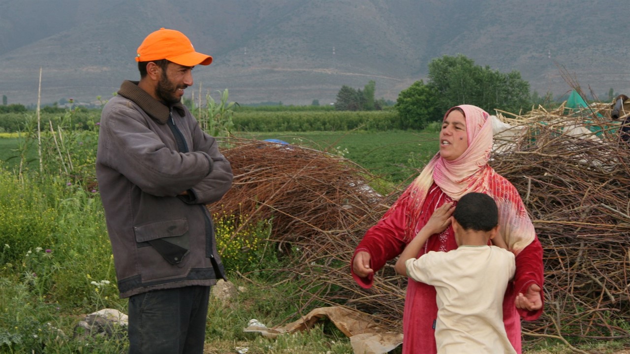 Man talking to a woman with a child