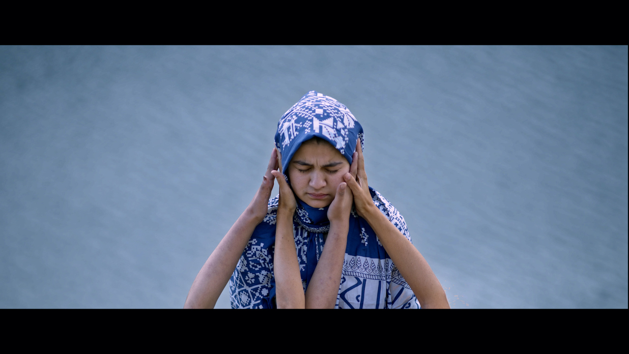 Woman with hands reaching up to her face