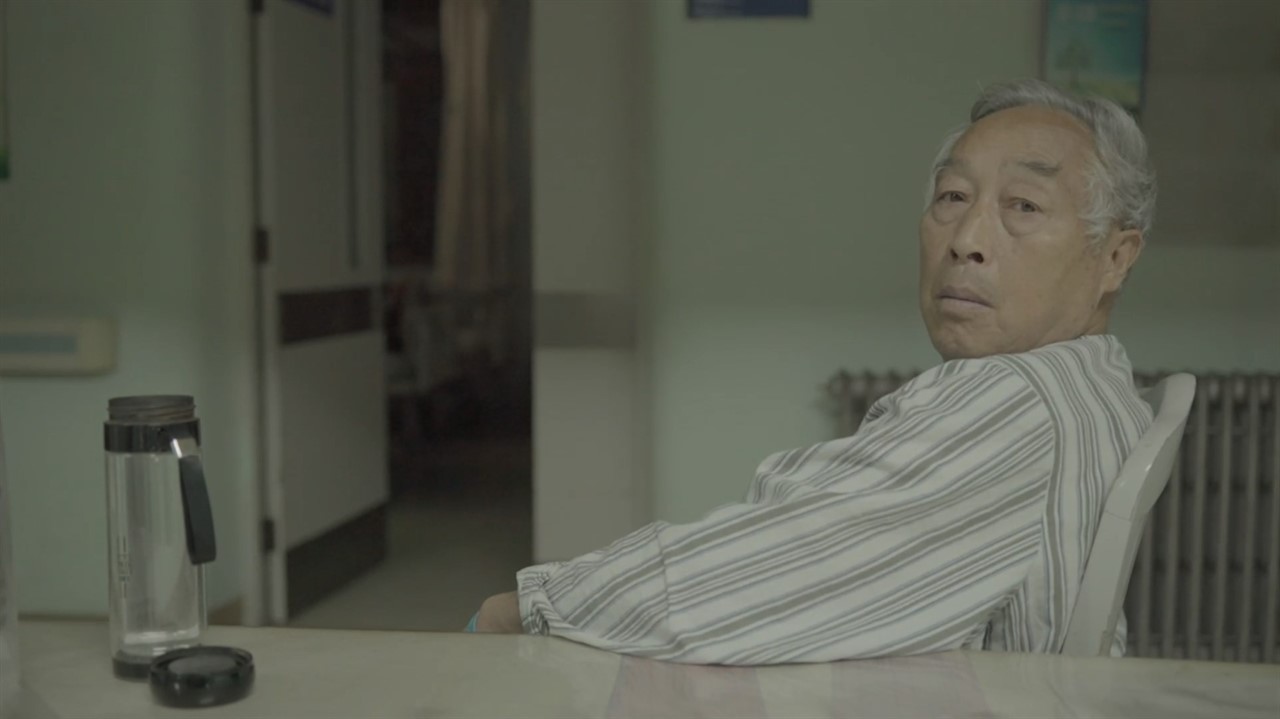 Chinese man sitting at a table