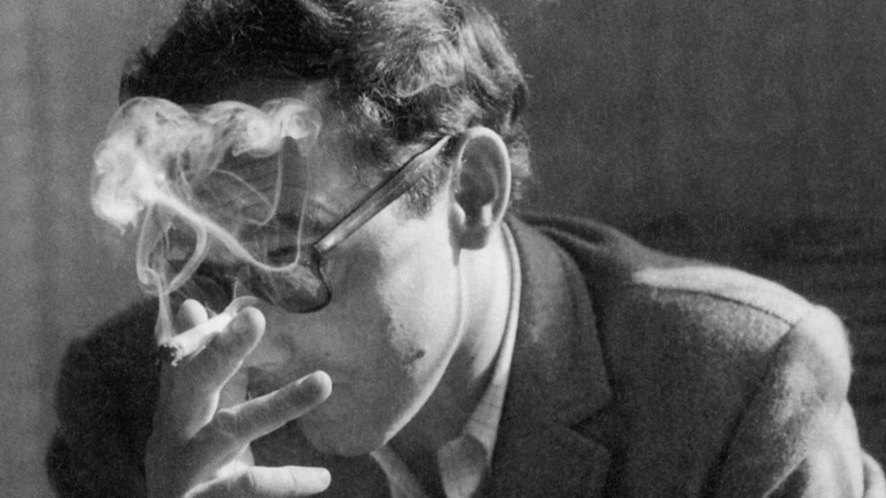 a man with glasses smoking