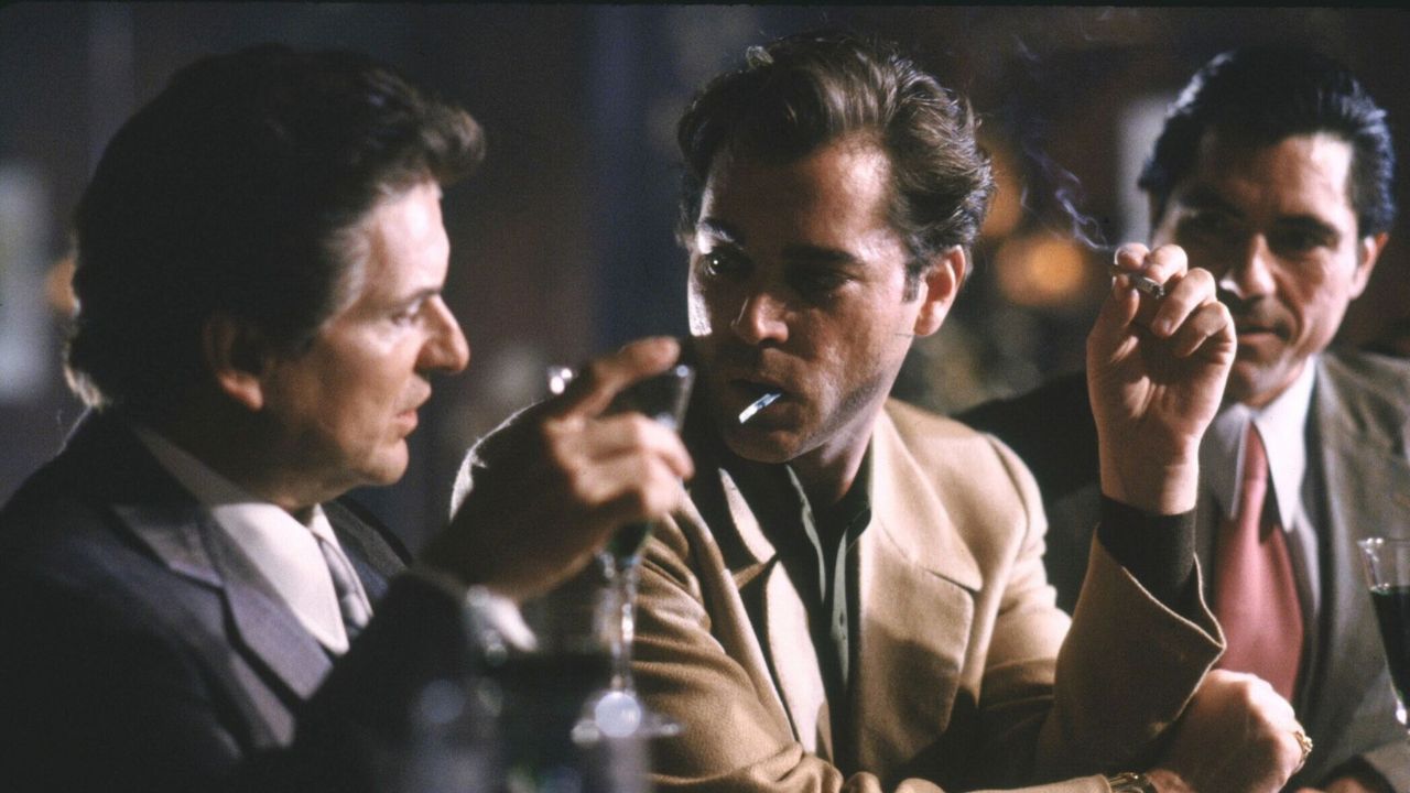 three men smoking and drinking