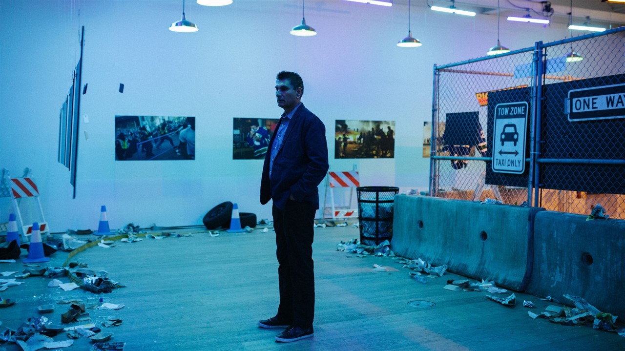 Man stands in a museum mirroring the Vancouver hoc