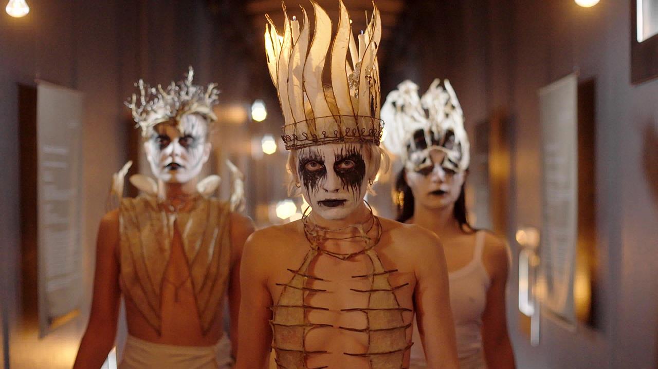 Three women in witch costumes and makeup