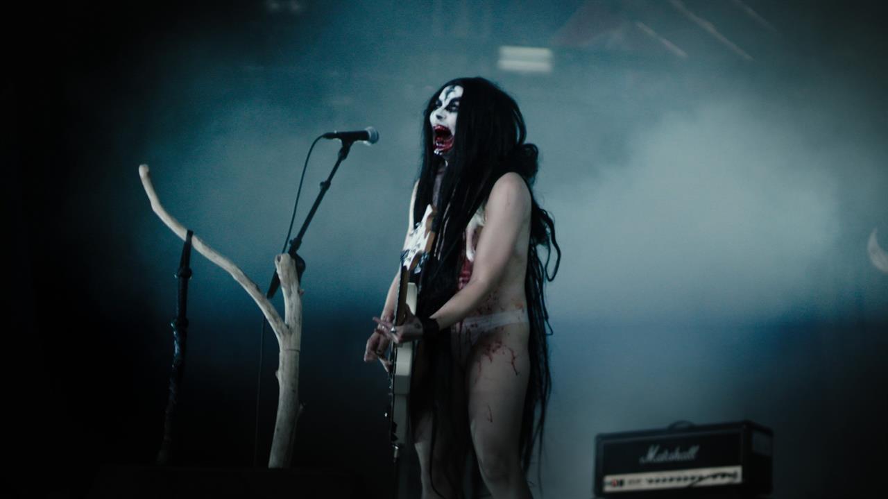 A demonic witch plays guitar