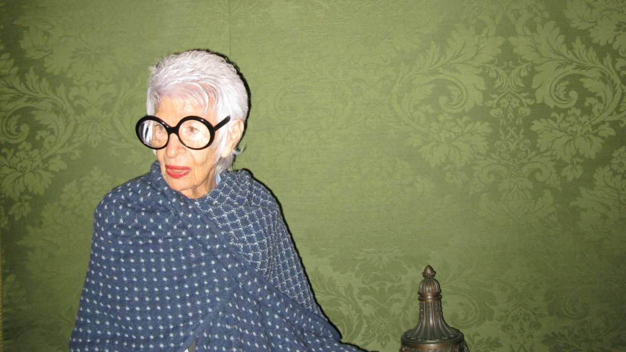 a woman with large round glasses