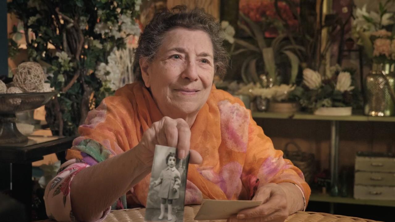 Woman showing old photo of young girl