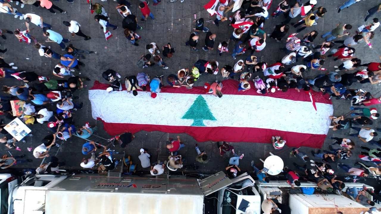a crowd of people around a flag