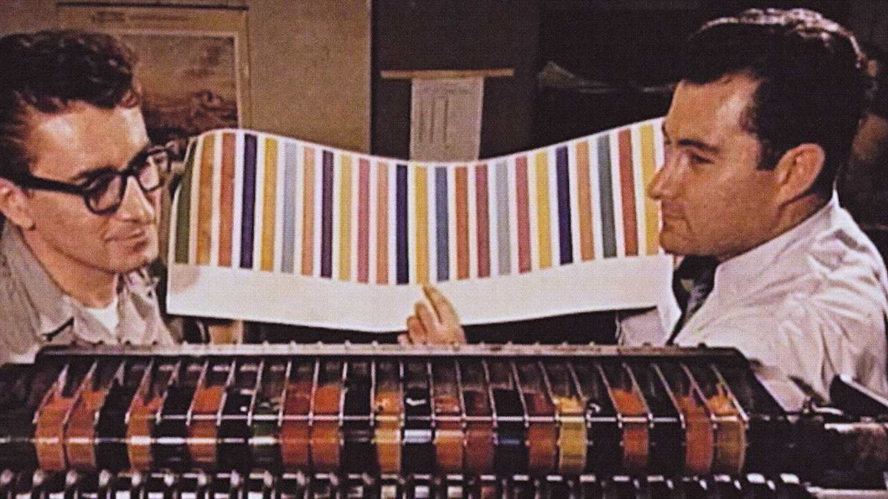 vintage photo of 2 men with a sheet of colours