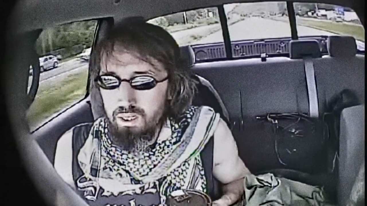 a man with sunglasses and a beard in a car