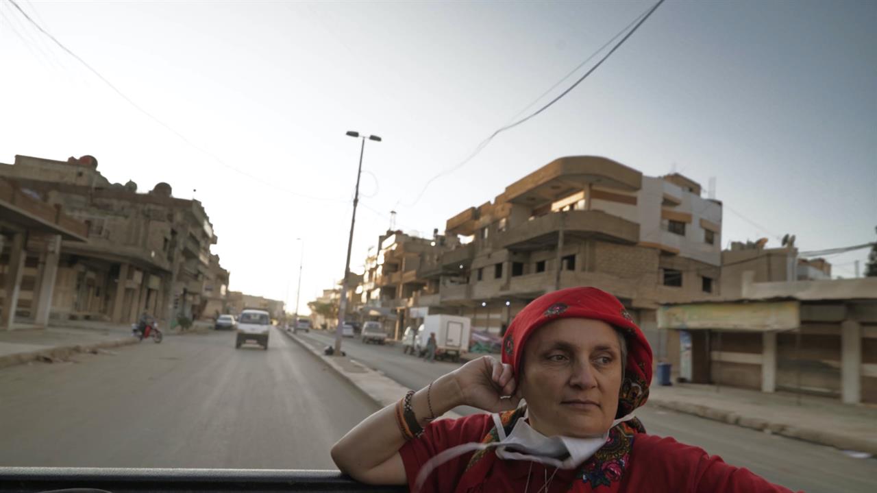 a woman with a red head scarf in a truck