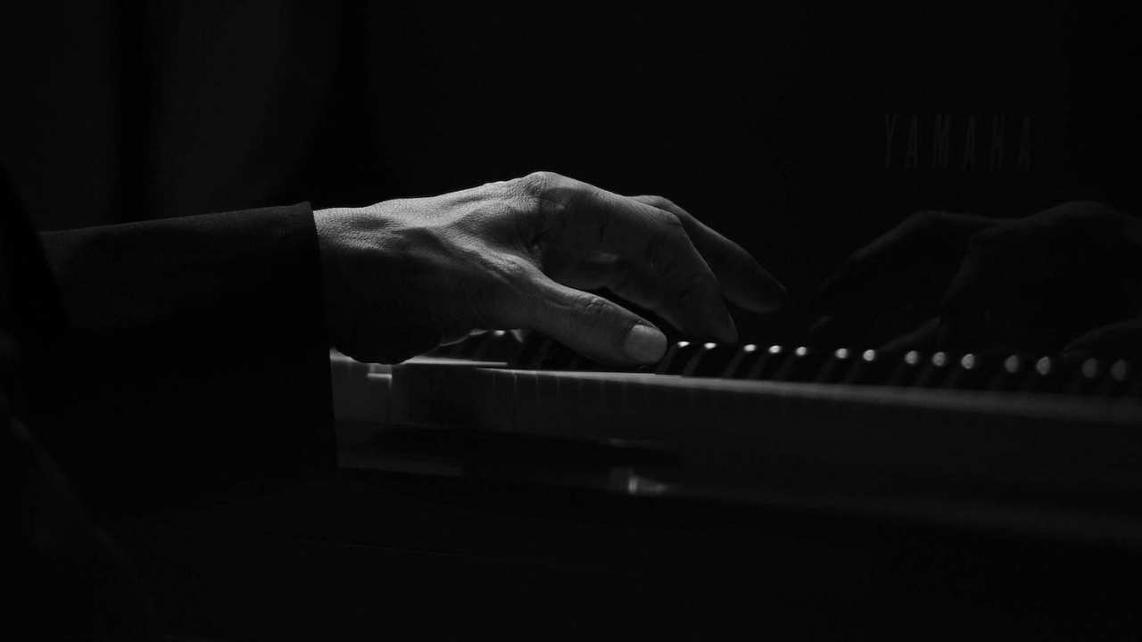 closeup of a hand playing the piano