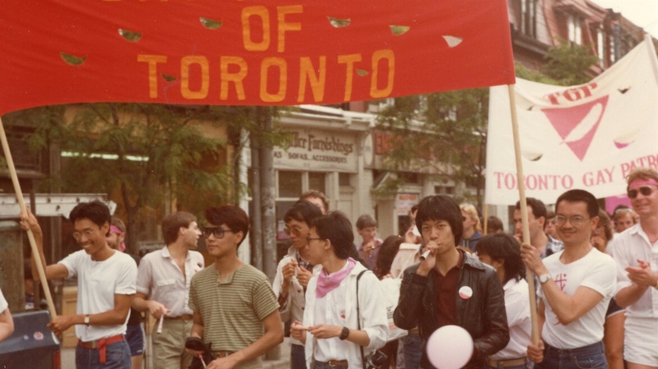 a group of people marching holding banners