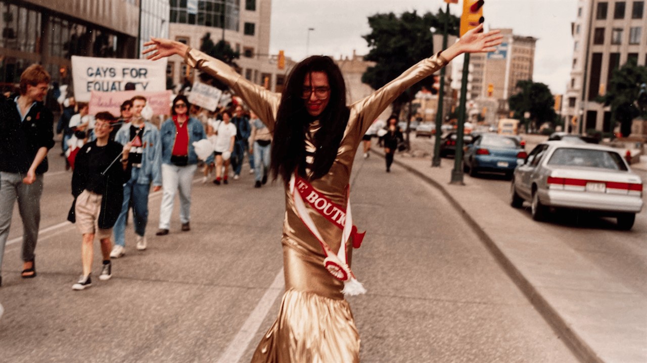 a person in a gold dress walking down a road