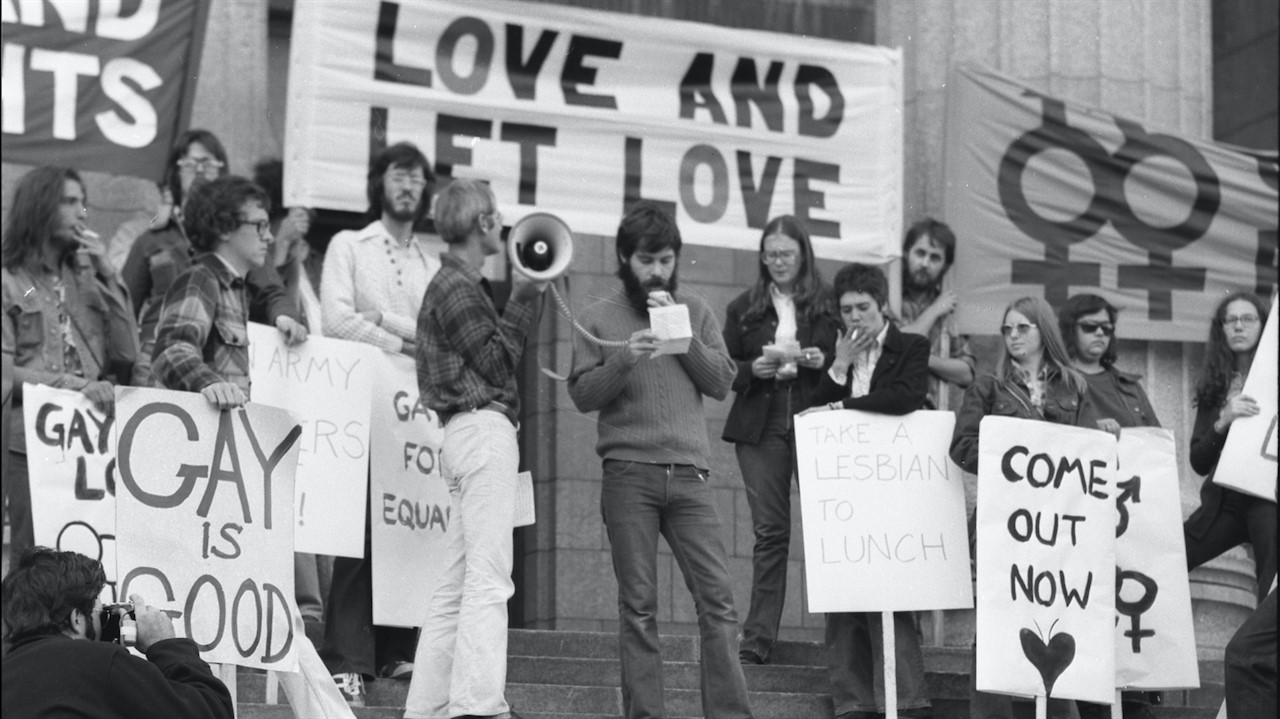 a group of people with banners and a megaphone