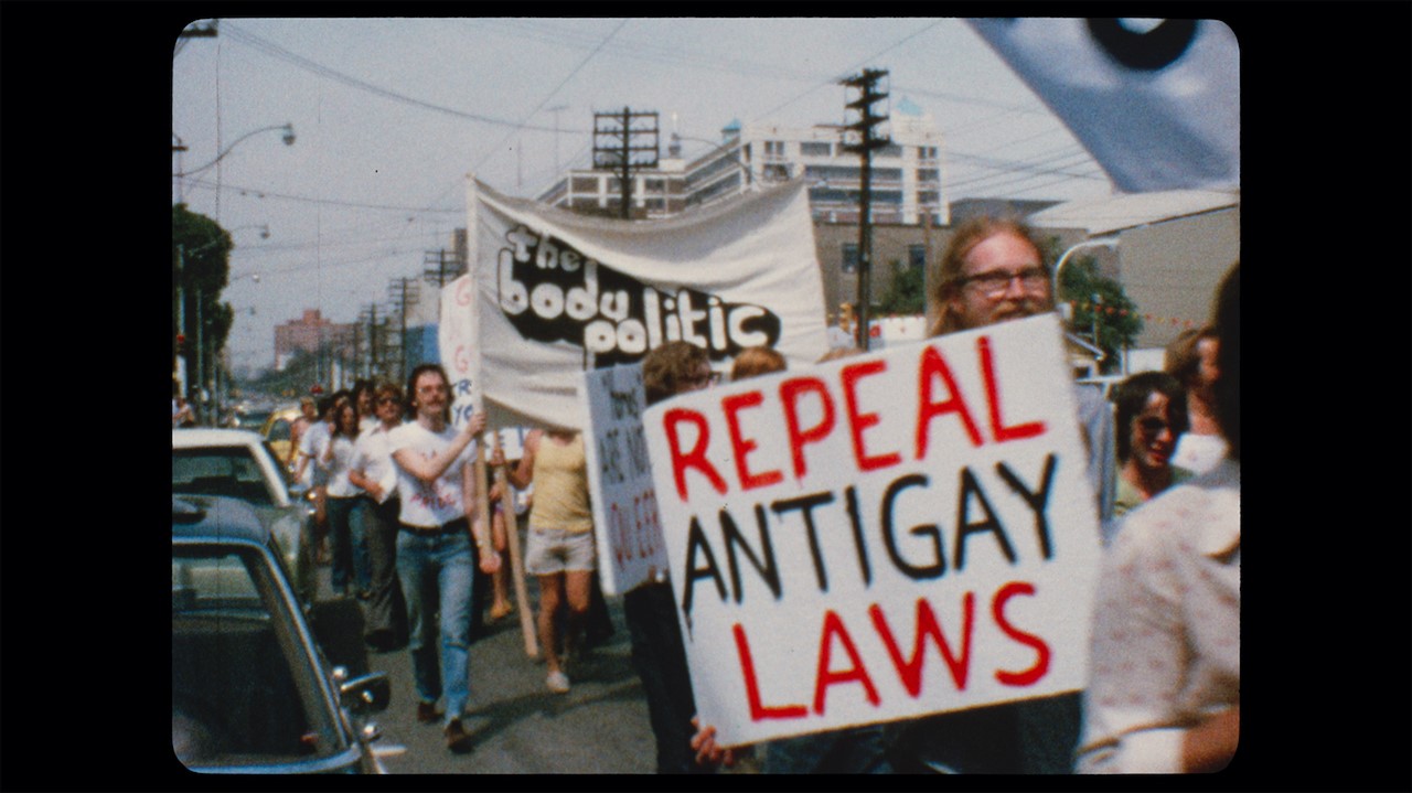 footage of people marching with signs and banners